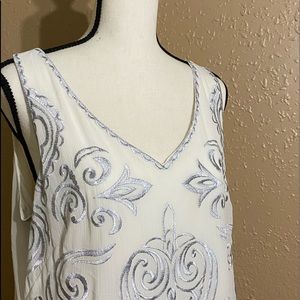 White House Black Market white and silver shell in size large.